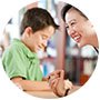 elementary school teacher laughing with boy student