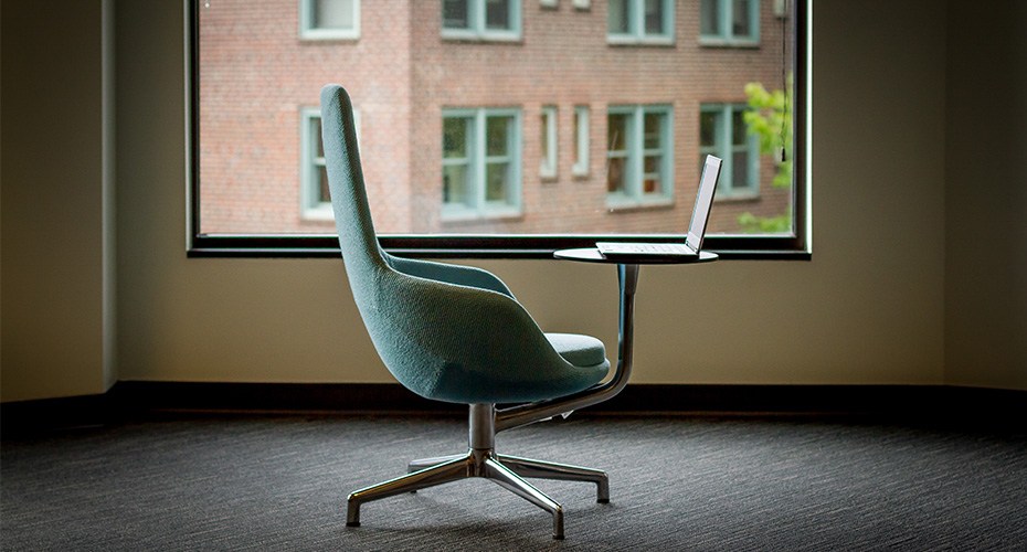 chair and laptop with view signifying a perk of earning a degree online