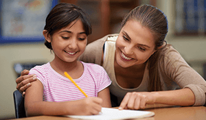 student teacher helping young student