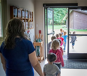 teacher walking with young students