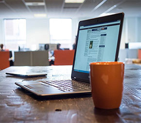 laptop computer and coffee cup