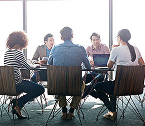 team of business people meeting together in boardroom