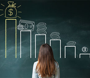 woman standing in front of chalkboard displaying graphic drawing depicting increasing money