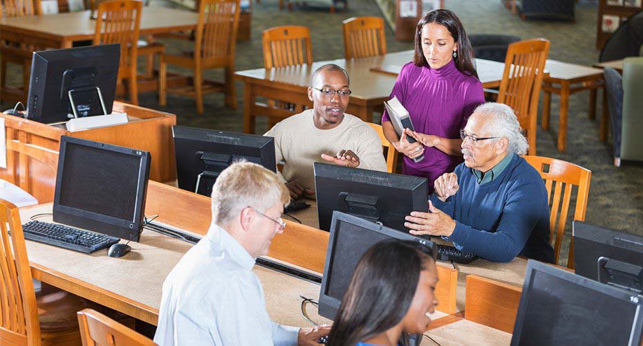 adult education leads classroom at night school