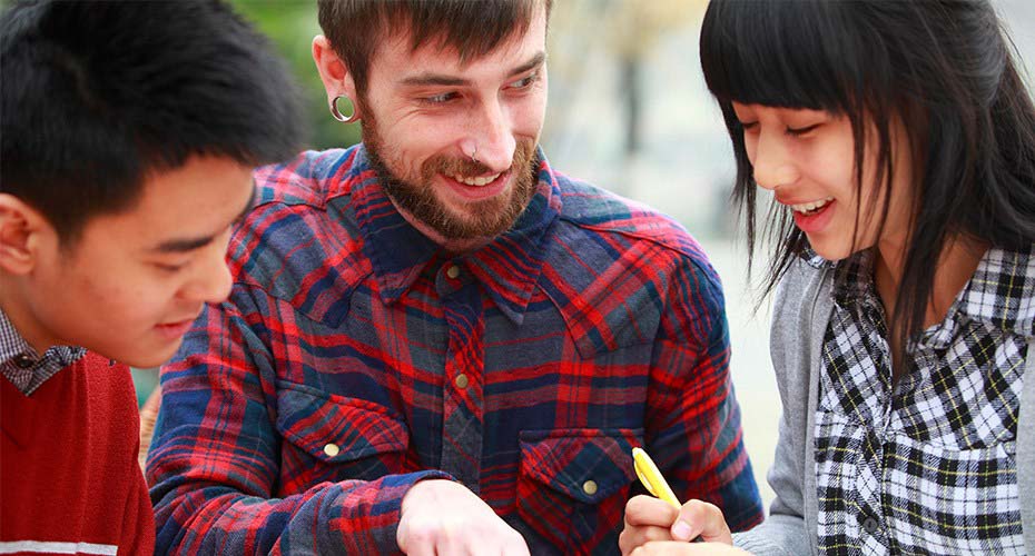 esl teacher working with international students on language skills