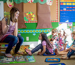 reading teacher at storytelling time with young students