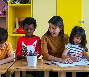 female teacher with three diverse students
