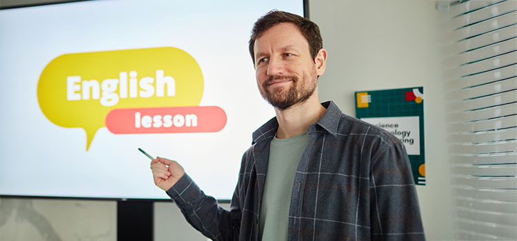 massachusetts esl teacher points to powerpoint english lesson