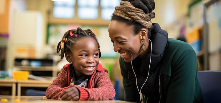 smiling special ed preschool teacher works with young girl